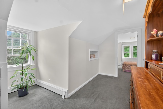 5776 Albany Post Rd, Cortlandt Manor, NY 10567 - hallway featuring dark colored carpet, lofted ceiling, and a baseboard radiator