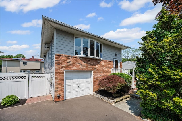 11 Trescott St, Dix Hills, NY 11746 - view of side of home featuring an attached garage, brick siding, and driveway
