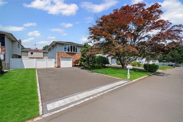 11 Trescott St, Dix Hills, NY 11746 - view of front of house with brick siding, asphalt driveway, and a garage