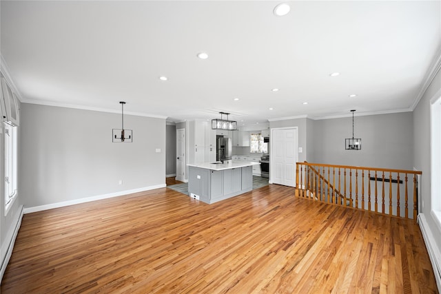 11 Trescott St, Dix Hills, NY 11746 - unfurnished living room with ornamental molding, light wood-type flooring, recessed lighting, a chandelier, and baseboard heating