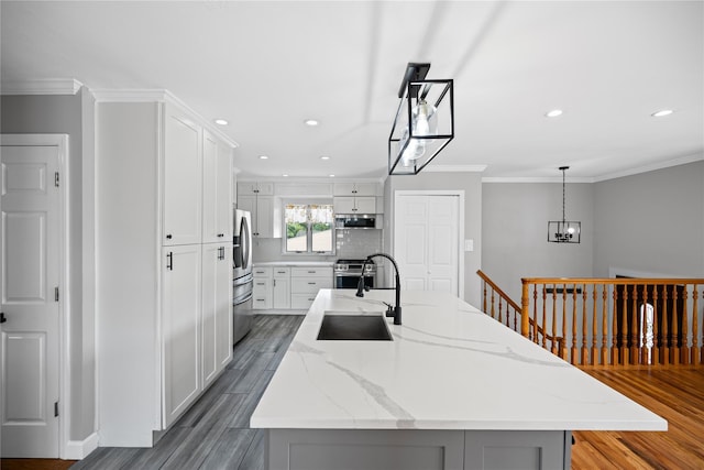 11 Trescott St, Dix Hills, NY 11746 - kitchen with stainless steel appliances, light wood-style flooring, crown molding, recessed lighting, and a kitchen island with sink