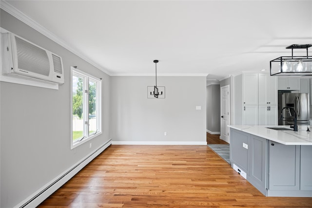 11 Trescott St, Dix Hills, NY 11746 - unfurnished dining area featuring a baseboard radiator, ornamental molding, light wood-type flooring, and a wall mounted AC