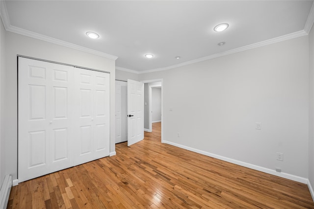 11 Trescott St, Dix Hills, NY 11746 - unfurnished bedroom with light wood-style floors, crown molding, recessed lighting, a closet, and a baseboard radiator