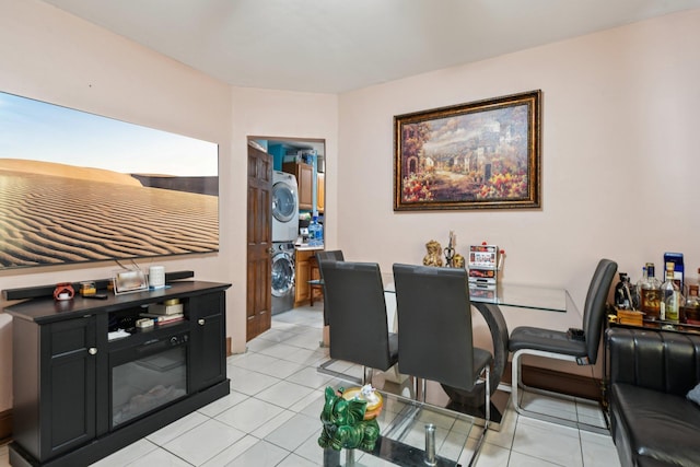 9406 76th St, Ozone Park, NY 11416 - dining area with estacked washer and dryer and light tile patterned floors