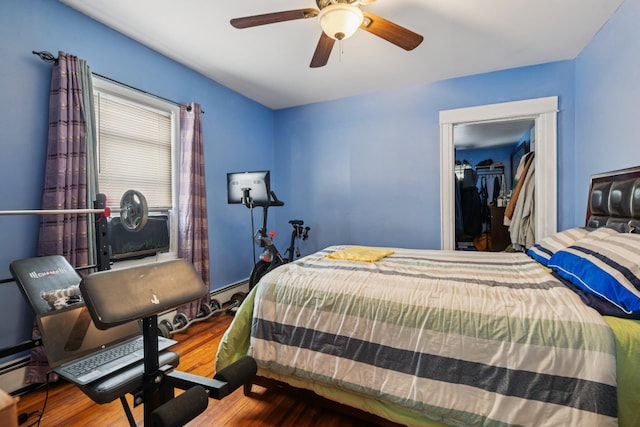 9406 76th St, Ozone Park, NY 11416 - bedroom with wood finished floors, a closet, ceiling fan, and a spacious closet