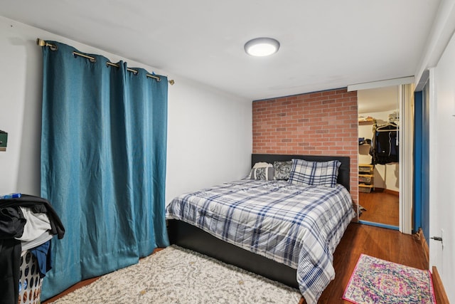 9406 76th St, Ozone Park, NY 11416 - bedroom featuring wood finished floors and a walk in closet