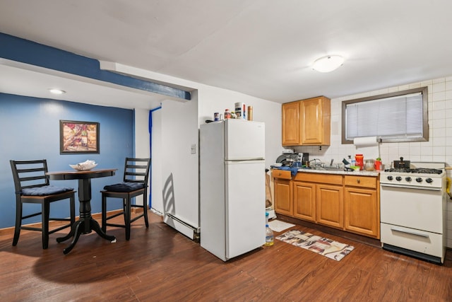 9406 76th St, Ozone Park, NY 11416 - kitchen with white appliances, dark wood-style floors, a baseboard heating unit, brown cabinetry, and light countertops