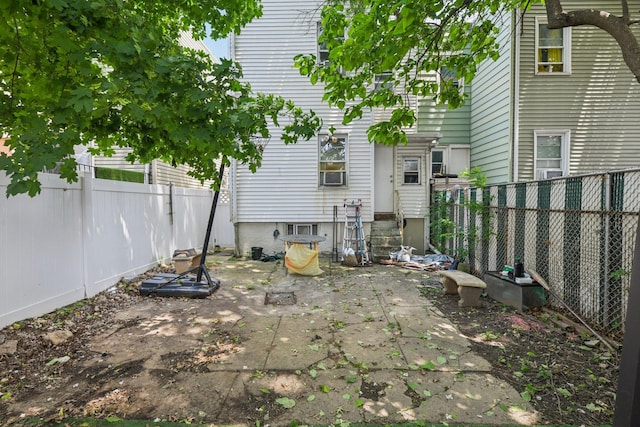 9406 76th St, Ozone Park, NY 11416 - rear view of property featuring entry steps, a fenced backyard, and a patio