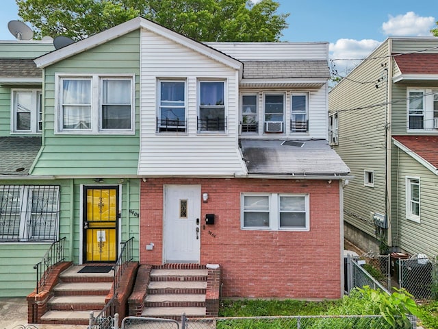 9406 76th St, Ozone Park, NY 11416 - view of property with entry steps, brick siding, and a shingled roof