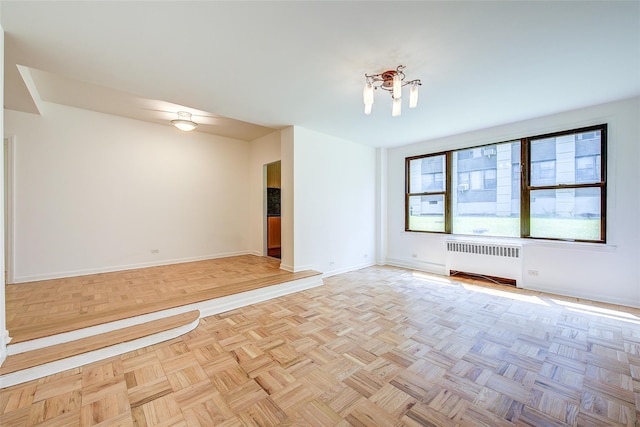 98-22 63rd Dr Unit 1D, Rego Park, NY 11374 - empty room featuring radiator and baseboards