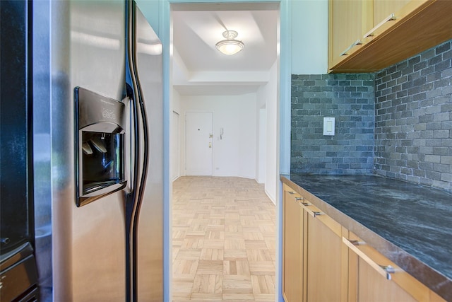 98-22 63rd Dr Unit 1D, Rego Park, NY 11374 - kitchen featuring stainless steel refrigerator with ice dispenser, dark countertops, decorative backsplash, and light brown cabinetry