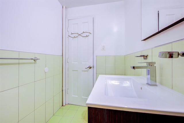 98-22 63rd Dr Unit 1D, Rego Park, NY 11374 - bathroom featuring tile walls, vanity, tile patterned flooring, and a wainscoted wall