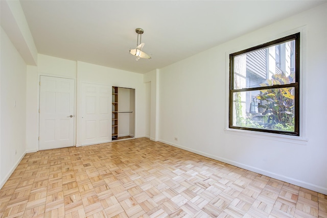 98-22 63rd Dr Unit 1D, Rego Park, NY 11374 - unfurnished bedroom featuring baseboards and a closet