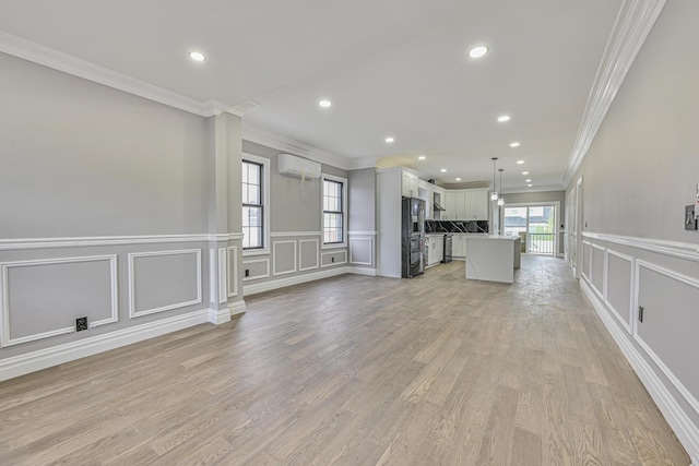 108 Bismark Ave, Valley Stream, NY 11581 - unfurnished living room with a wall mounted air conditioner, a decorative wall, crown molding, recessed lighting, and wainscoting