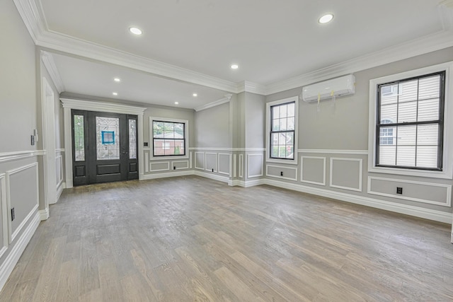 108 Bismark Ave, Valley Stream, NY 11581 - foyer with a wall mounted AC, a decorative wall, a wainscoted wall, wood finished floors, and ornamental molding