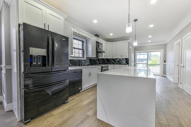108 Bismark Ave, Valley Stream, NY 11581 - kitchen with black appliances, ornamental molding, light stone countertops, a center island, and white cabinetry