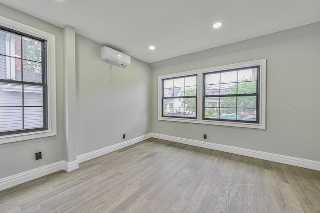 108 Bismark Ave, Valley Stream, NY 11581 - unfurnished room featuring an AC wall unit, wood finished floors, and recessed lighting