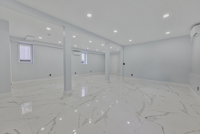 108 Bismark Ave, Valley Stream, NY 11581 - below grade area with a wall unit AC, recessed lighting, healthy amount of natural light, and light marble finish flooring