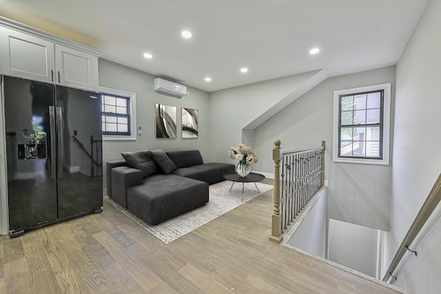 108 Bismark Ave, Valley Stream, NY 11581 - living area featuring an AC wall unit, light wood-style floors, recessed lighting, and healthy amount of natural light