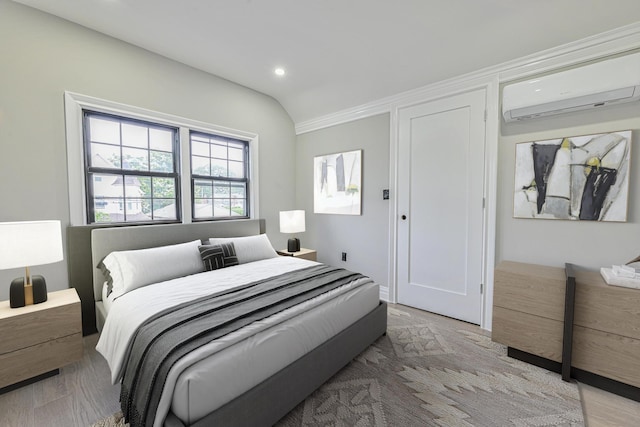108 Bismark Ave, Valley Stream, NY 11581 - bedroom featuring an AC wall unit, recessed lighting, vaulted ceiling, and light wood-type flooring