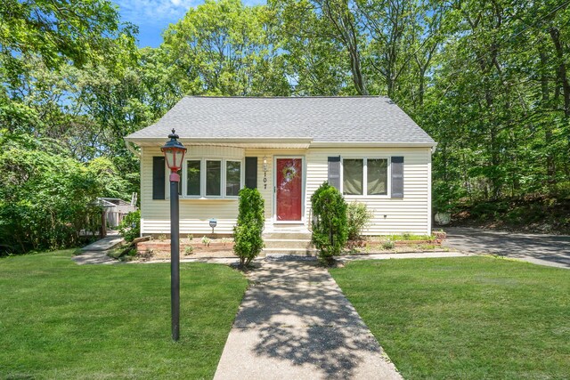 107 Cedar Ln, Medford, NY 11763 - view of front facade with a shingled roof and a front lawn