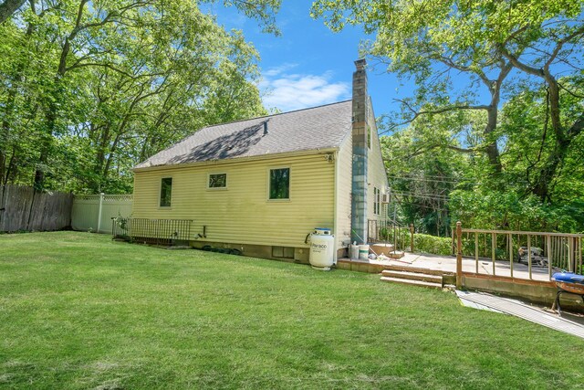 107 Cedar Ln, Medford, NY 11763 - view of property exterior featuring a deck, a chimney, and roof with shingles