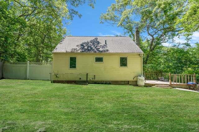 107 Cedar Ln, Medford, NY 11763 - back of house featuring crawl space, a wooden deck, a chimney, and a shingled roof