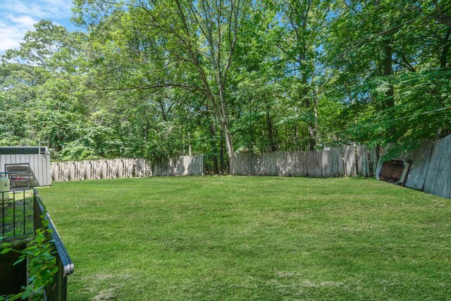107 Cedar Ln, Medford, NY 11763 - fenced backyard with a shed