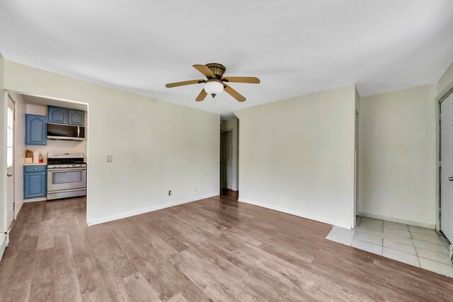 107 Cedar Ln, Medford, NY 11763 - unfurnished living room with light wood finished floors and a ceiling fan