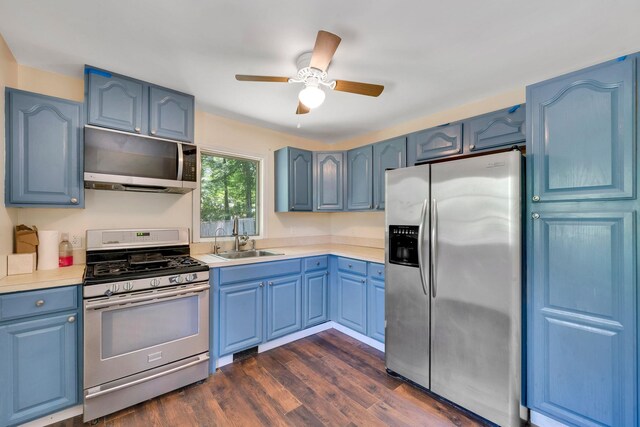 107 Cedar Ln, Medford, NY 11763 - kitchen featuring stainless steel appliances, blue cabinets, light countertops, and a ceiling fan