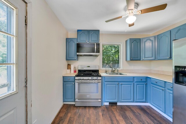 107 Cedar Ln, Medford, NY 11763 - kitchen with appliances with stainless steel finishes, blue cabinets, dark wood-style flooring, and light countertops