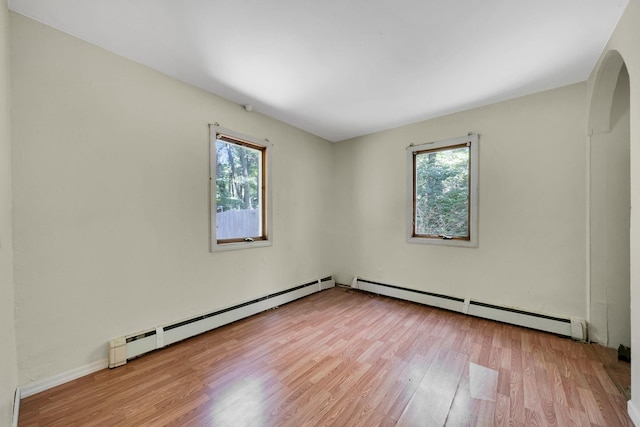 107 Cedar Ln, Medford, NY 11763 - unfurnished room with a baseboard heating unit and wood finished floors