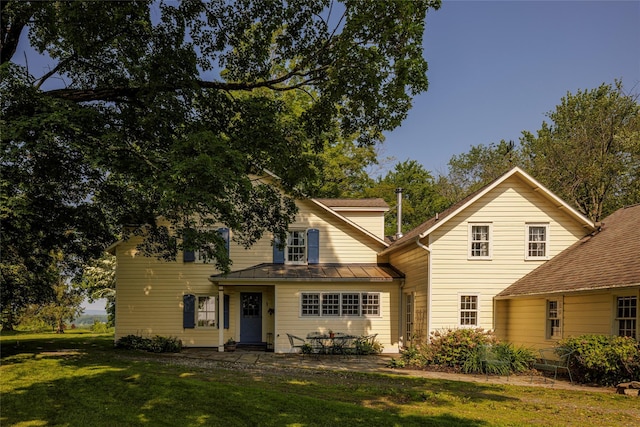 797 Western Rd, Call Listing Agent, NY 12033 - traditional home with a front yard, a standing seam roof, a patio, and a metal roof