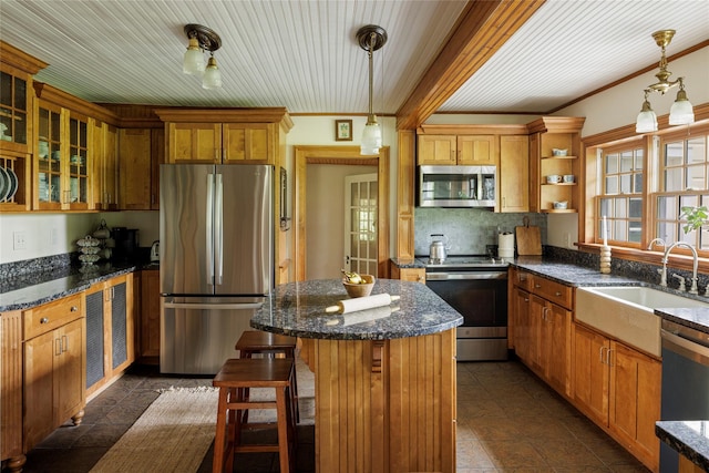 797 Western Rd, Call Listing Agent, NY 12033 - kitchen featuring stainless steel appliances, ornamental molding, a kitchen island, glass insert cabinets, and a kitchen breakfast bar