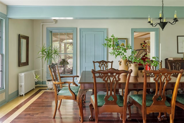 797 Western Rd, Call Listing Agent, NY 12033 - dining room with radiator, a chandelier, and wood finished floors