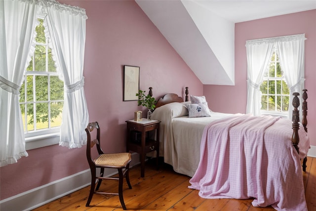 797 Western Rd, Call Listing Agent, NY 12033 - bedroom featuring multiple windows, hardwood / wood-style floors, and vaulted ceiling