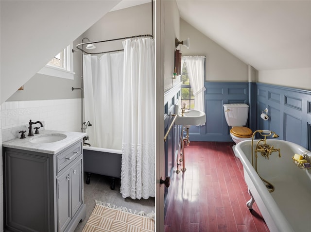 797 Western Rd, Call Listing Agent, NY 12033 - bathroom with vaulted ceiling, wood finished floors, a wainscoted wall, shower / bath combo, and vanity