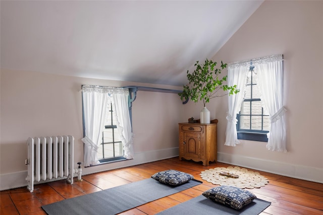 797 Western Rd, Call Listing Agent, NY 12033 - exercise area with radiator, vaulted ceiling, and hardwood / wood-style floors