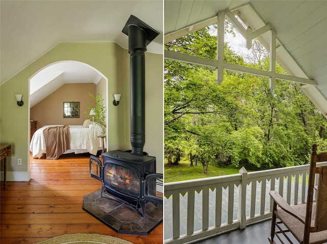 797 Western Rd, Call Listing Agent, NY 12033 - living area with lofted ceiling, a wood stove, hardwood / wood-style floors, and arched walkways