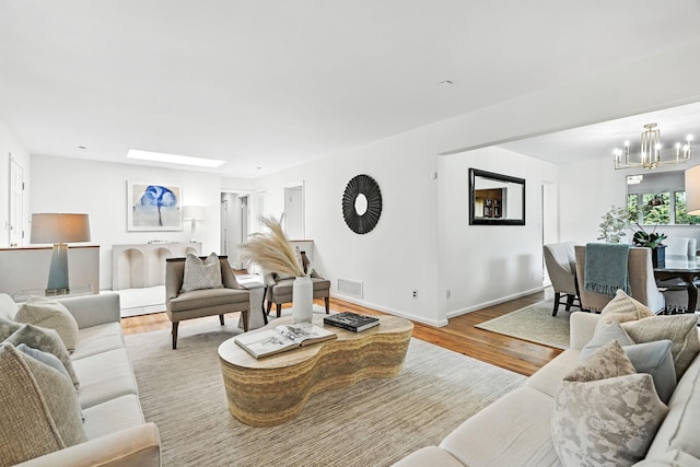65 Shepherds Dr, Scarsdale, NY 10583 - living room featuring a chandelier and wood finished floors