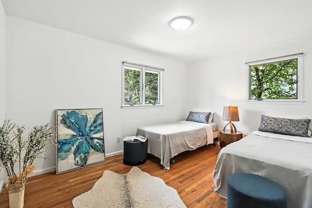 65 Shepherds Dr, Scarsdale, NY 10583 - bedroom with multiple windows and wood finished floors