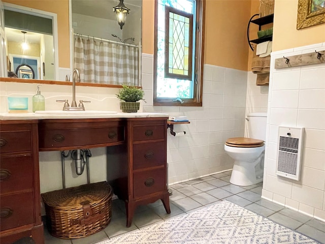 457 Fire Island Blvd, Fire Island Pines, NY 11782 - full bath with wainscoting, tile walls, tile patterned floors, heating unit, and vanity