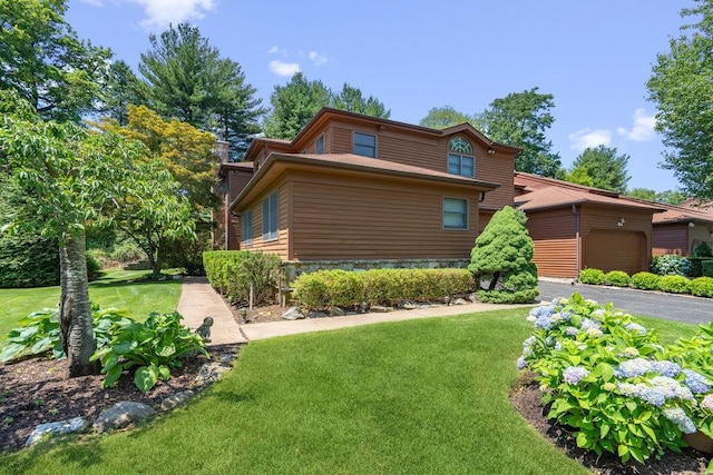 43 Hunt Dr, Jericho, NY 11753 - view of front of home with an attached garage, a front yard, and driveway