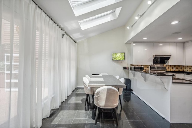 43 Hunt Dr, Jericho, NY 11753 - dining area featuring granite tiled floors, a skylight, vaulted ceiling, and recessed lighting