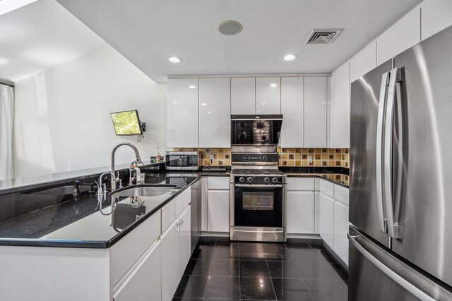 43 Hunt Dr, Jericho, NY 11753 - kitchen with stainless steel appliances, a peninsula, granite floors, white cabinetry, and recessed lighting