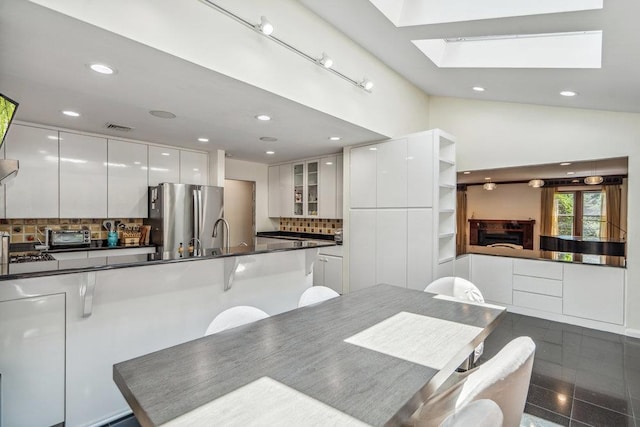 43 Hunt Dr, Jericho, NY 11753 - dining room with recessed lighting, a skylight, granite floors, and a high ceiling
