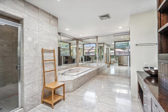 43 Hunt Dr, Jericho, NY 11753 - bathroom featuring healthy amount of natural light, a whirlpool tub, a stall shower, and recessed lighting