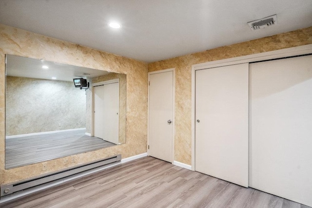 43 Hunt Dr, Jericho, NY 11753 - unfurnished bedroom with a baseboard radiator, wood finished floors, a closet, and recessed lighting