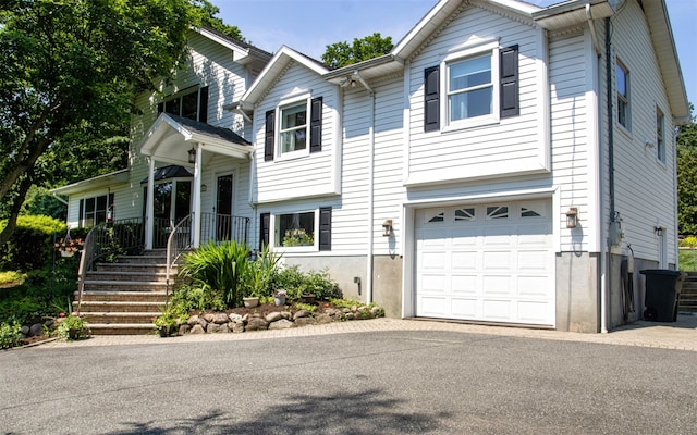 25 Mckinley St, Pearl River, NY 10965 - view of front of house featuring a garage and asphalt driveway