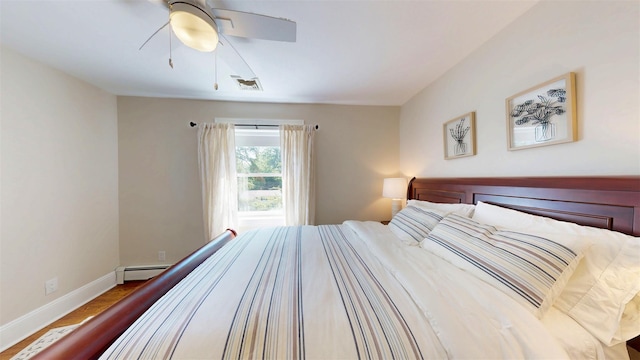 25 Mckinley St, Pearl River, NY 10965 - bedroom with baseboard heating, wood finished floors, and a ceiling fan